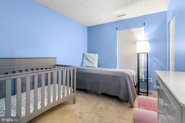 carpeted bedroom featuring a textured ceiling