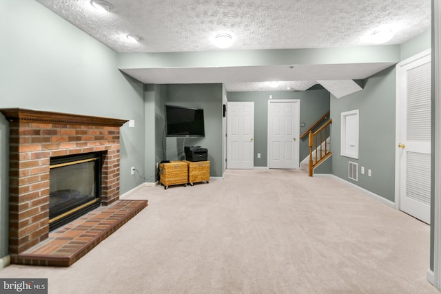 unfurnished living room featuring a brick fireplace, carpet floors, stairway, a textured ceiling, and baseboards