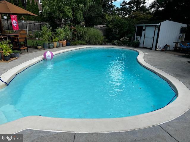 view of pool with fence and a patio