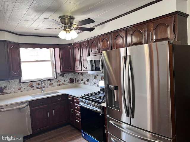 kitchen featuring stainless steel appliances, a sink, light countertops, and backsplash