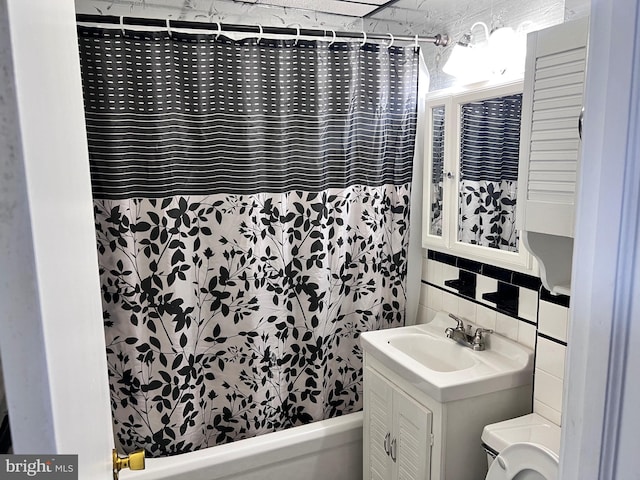 full bathroom featuring decorative backsplash, vanity, and shower / tub combo