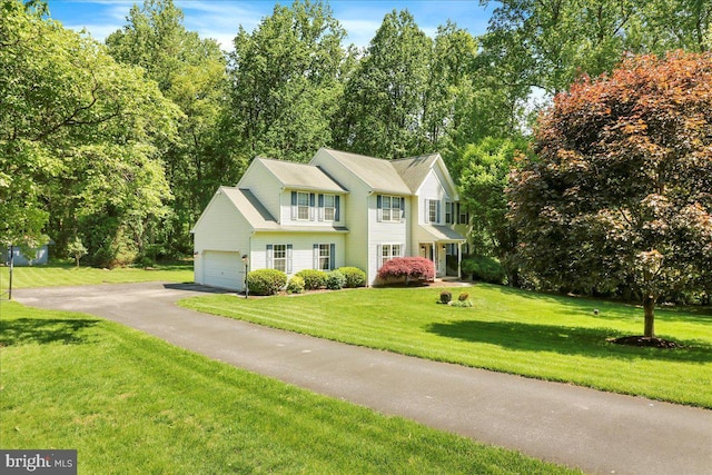 21 Bright Summer Way, Glenmoore, PA 19343 - view of front of property featuring asphalt driveway, a front yard, an attached garage, and view of wooded area