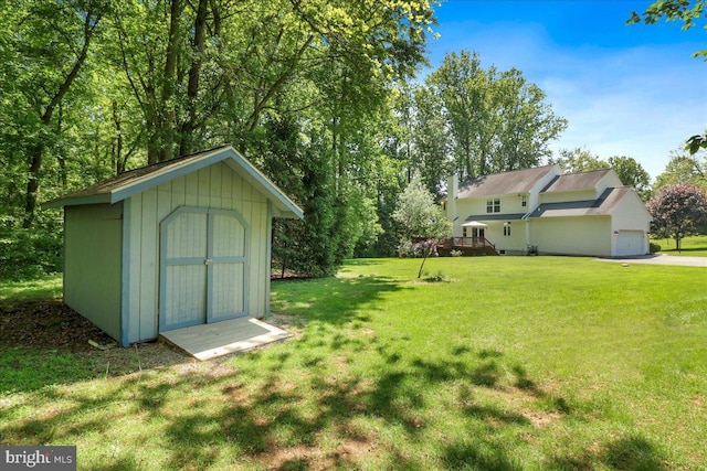 21 Bright Summer Way, Glenmoore, PA 19343 - view of green lawn with a storage unit, an outdoor structure, a garage, and a wooden deck