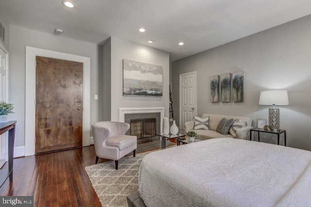 2129 Florida Ave NW Unit 507, Washington, DC 20008 - bedroom with hardwood / wood-style flooring, recessed lighting, and a tiled fireplace