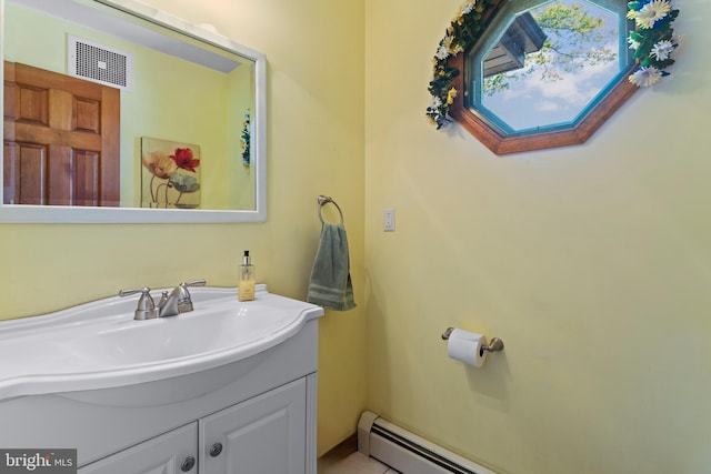 bathroom featuring vanity, a baseboard heating unit, and a skylight