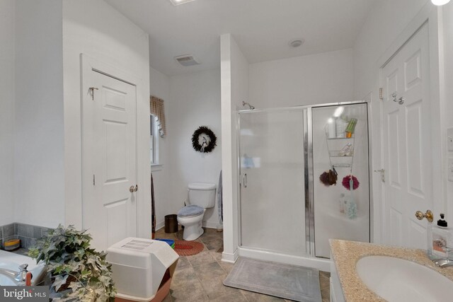 bathroom featuring toilet, a shower stall, tile patterned flooring, and vanity