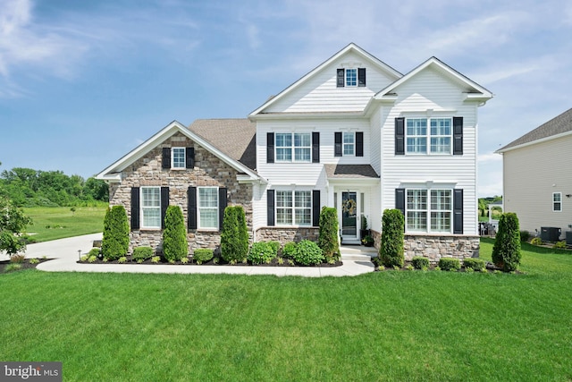 355 Dillon Cir, Middletown, DE 19709 - view of front facade featuring central AC, a front lawn, and stone siding