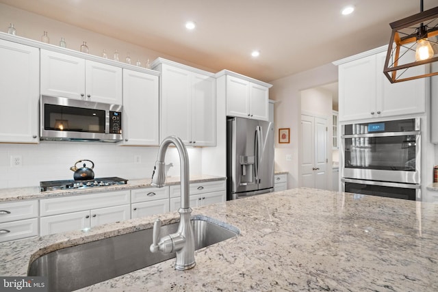 355 Dillon Cir, Middletown, DE 19709 - kitchen featuring stainless steel appliances, a sink, white cabinets, recessed lighting, and decorative backsplash