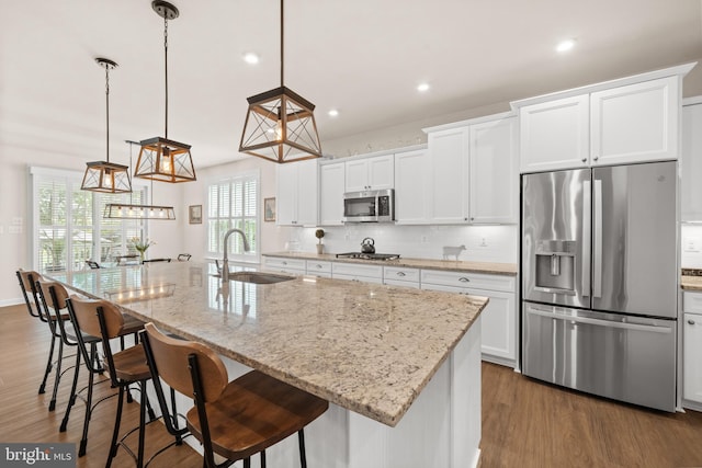355 Dillon Cir, Middletown, DE 19709 - kitchen with appliances with stainless steel finishes, a sink, dark wood-style flooring, backsplash, and white cabinets
