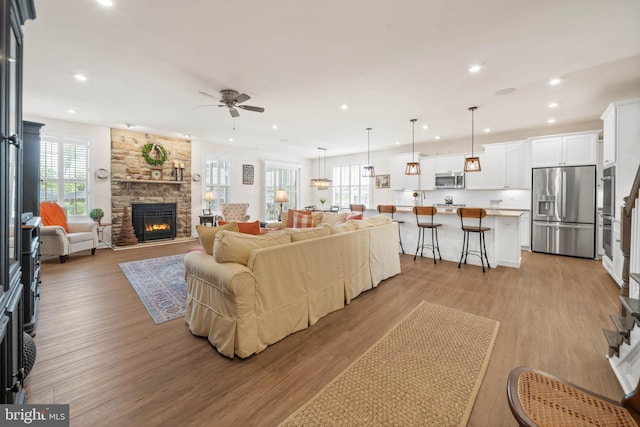 355 Dillon Cir, Middletown, DE 19709 - living room with a ceiling fan, recessed lighting, a stone fireplace, and light wood-type flooring