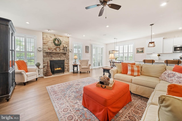 355 Dillon Cir, Middletown, DE 19709 - living area featuring plenty of natural light, light wood-type flooring, a stone fireplace, and recessed lighting