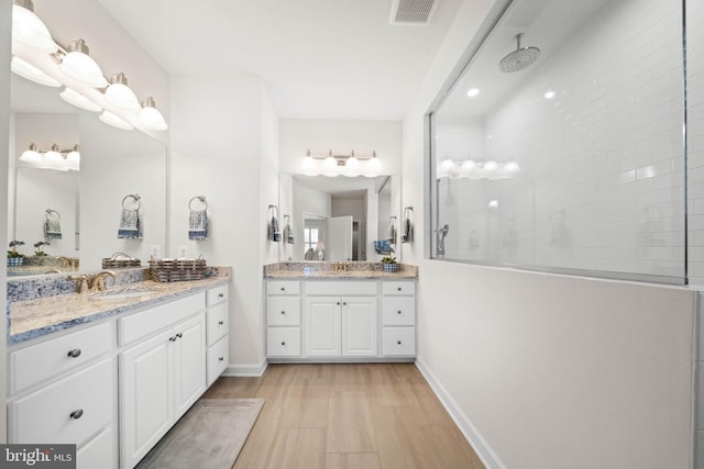355 Dillon Cir, Middletown, DE 19709 - bathroom with walk in shower, two vanities, baseboards, and wood finished floors