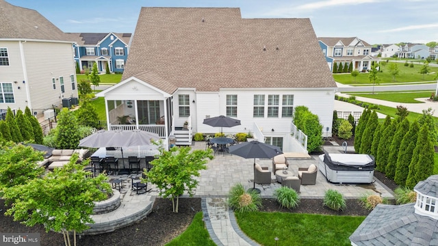 355 Dillon Cir, Middletown, DE 19709 - back of property featuring a hot tub, a patio area, outdoor dining area, and a residential view