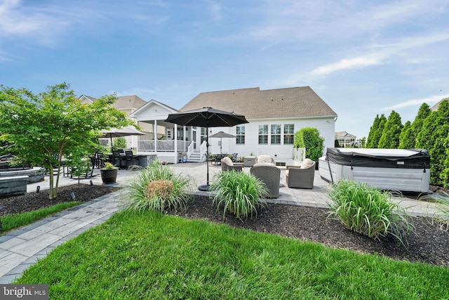 355 Dillon Cir, Middletown, DE 19709 - back of house with a hot tub, an outdoor living space, a patio area, and roof with shingles