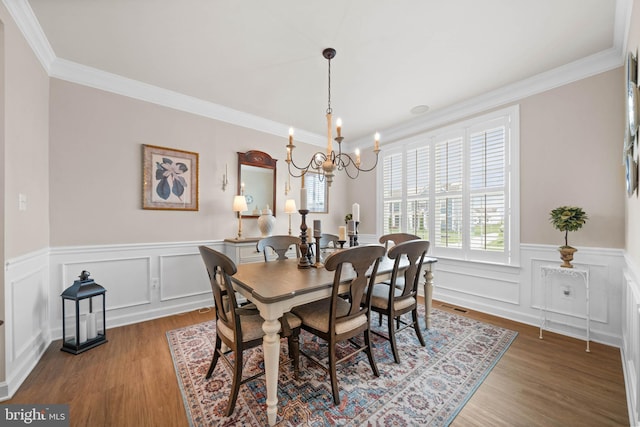 355 Dillon Cir, Middletown, DE 19709 - dining space featuring a chandelier, ornamental molding, wainscoting, wood finished floors, and a decorative wall