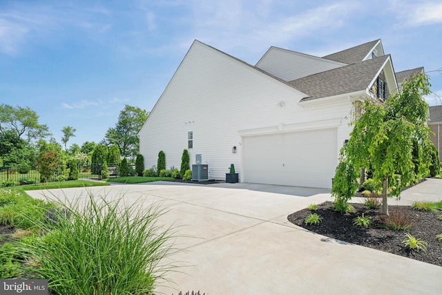 355 Dillon Cir, Middletown, DE 19709 - view of home's exterior featuring concrete driveway, roof with shingles, an attached garage, and central AC unit