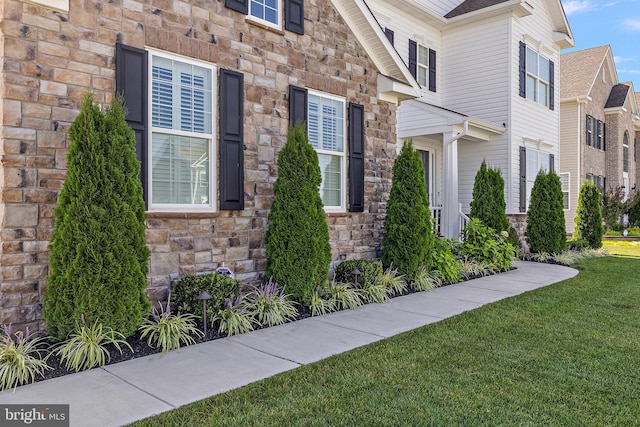 355 Dillon Cir, Middletown, DE 19709 - view of exterior entry featuring stone siding and a lawn