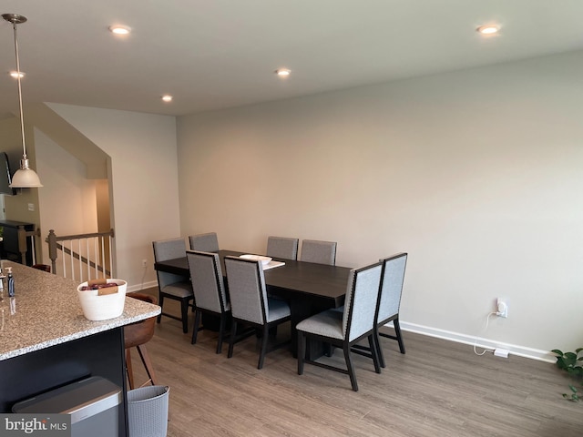dining room featuring light wood-type flooring, baseboards, and recessed lighting