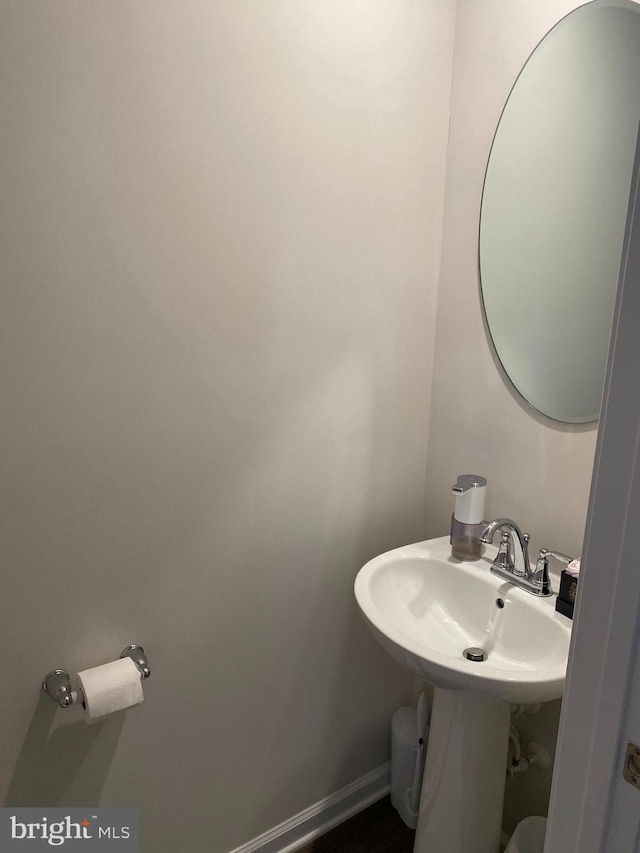 half bath featuring a sink