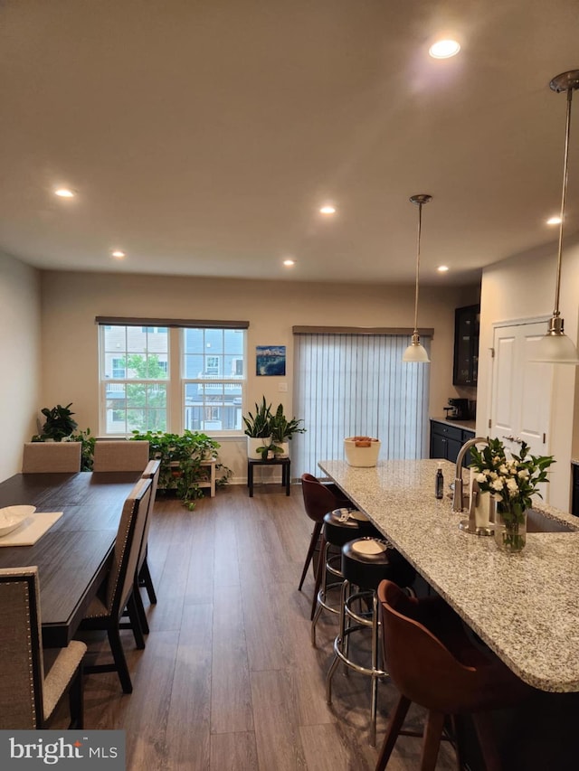 dining space with dark wood finished floors and recessed lighting