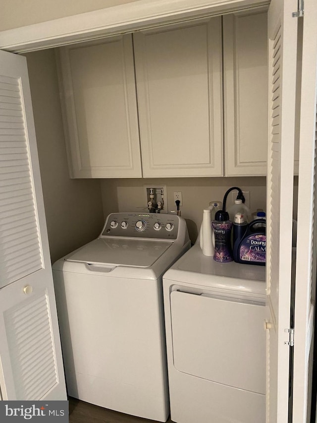 laundry area featuring independent washer and dryer and cabinet space