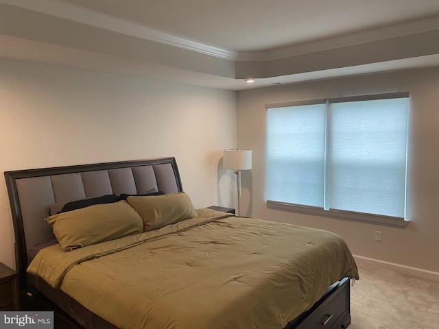 bedroom featuring ornamental molding, light colored carpet, and baseboards
