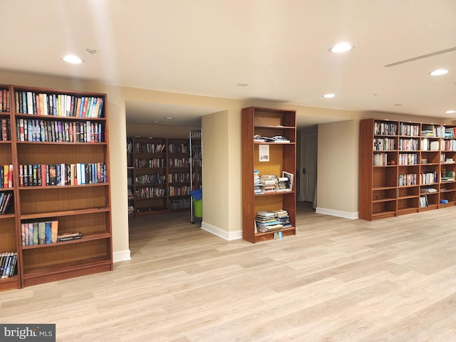 66 Franklin St Unit 307, Annapolis, MD 21401 - sitting room featuring bookshelves, wood finished floors, baseboards, and recessed lighting