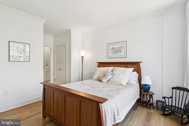 66 Franklin St Unit 307, Annapolis, MD 21401 - bedroom featuring ornamental molding, light wood-style flooring, baseboards, and ensuite bathroom