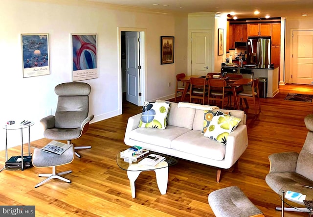 66 Franklin St Unit 307, Annapolis, MD 21401 - living area featuring wood finished floors, crown molding, and baseboards