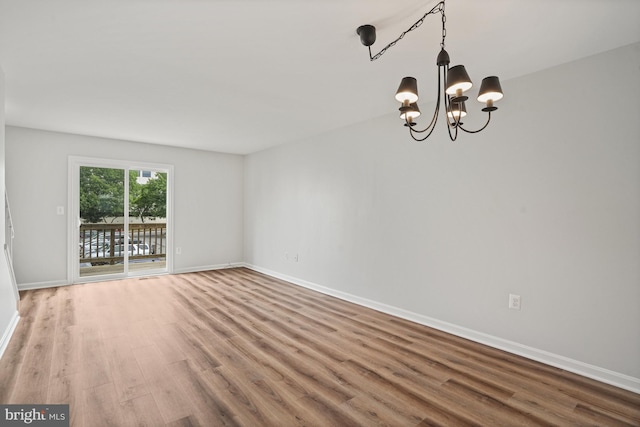 3823 9th Rd S, Arlington, VA 22204 - spare room featuring wood finished floors, a chandelier, and baseboards