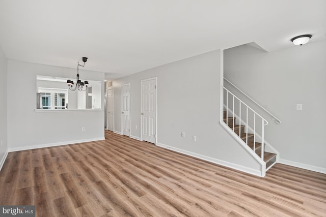 3823 9th Rd S, Arlington, VA 22204 - unfurnished living room with a chandelier, wood finished floors, stairs, and baseboards