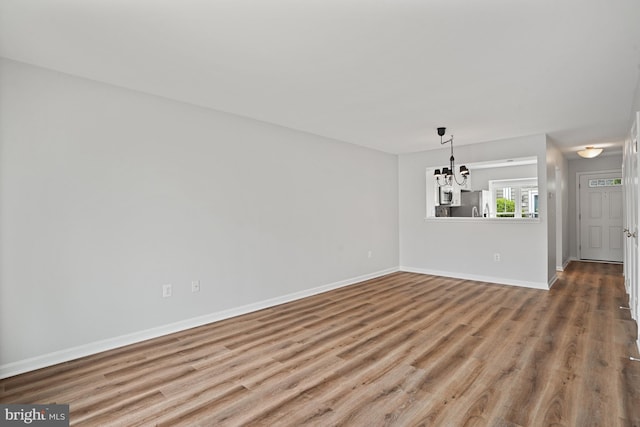 3823 9th Rd S, Arlington, VA 22204 - unfurnished dining area with a chandelier, wood finished floors, and baseboards