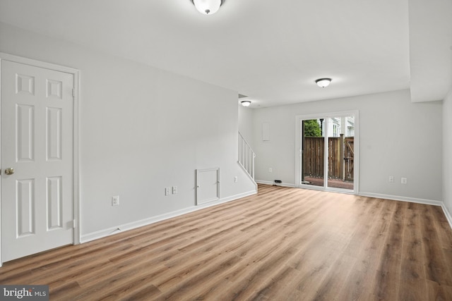 3823 9th Rd S, Arlington, VA 22204 - unfurnished living room featuring stairway, wood finished floors, and baseboards