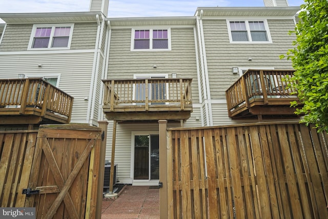 3823 9th Rd S, Arlington, VA 22204 - rear view of property with a gate, cooling unit, fence, and a chimney