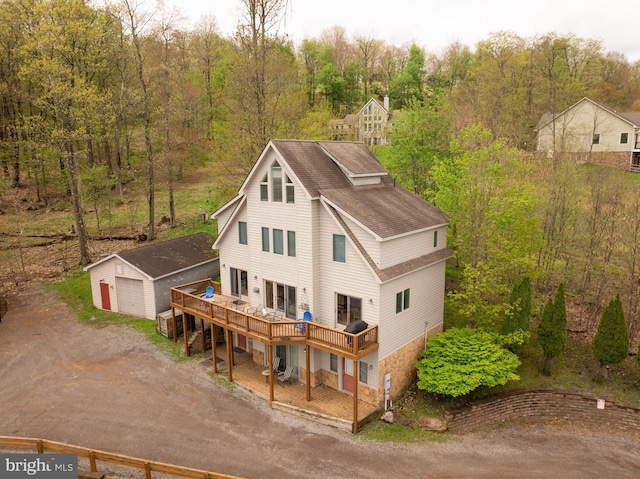 175 Roman Ridge Rd Unit 15, Oakland, MD 21550 - rear view of property with an outbuilding, dirt driveway, a wooden deck, roof with shingles, and a garage