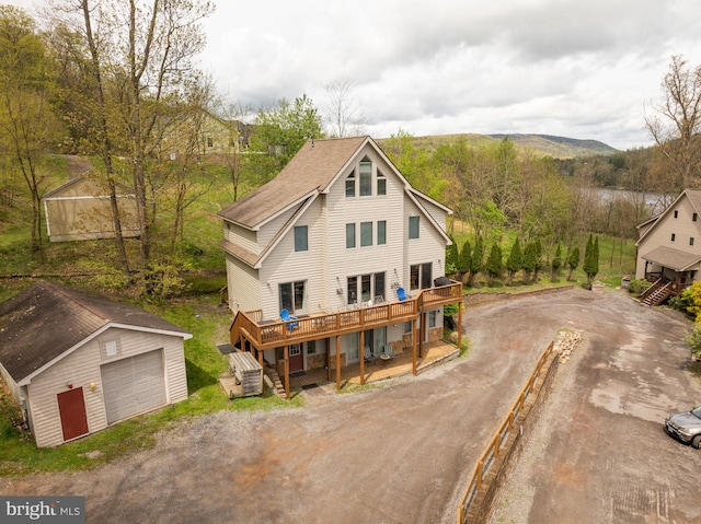 175 Roman Ridge Rd Unit 15, Oakland, MD 21550 - rustic home featuring an outdoor structure, a deck, dirt driveway, and a garage