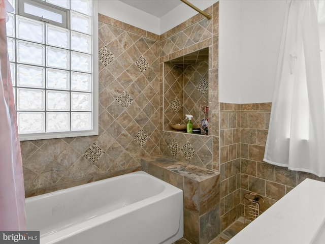 4511 Powell Ave, Baltimore, MD 21206 - bathroom with a tile shower, tile walls, and a tub
