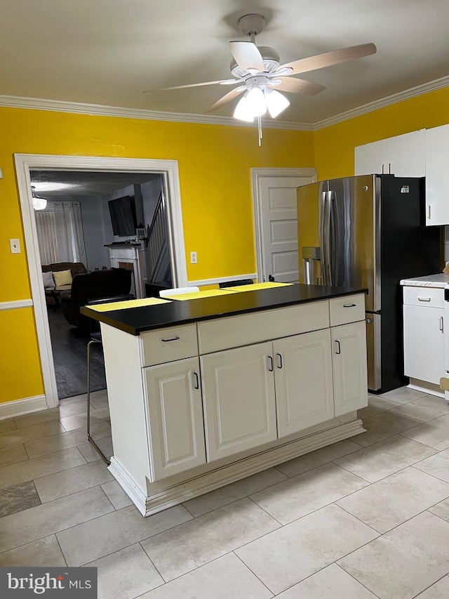 453 Bert Ave, Trenton, NJ 08629 - kitchen featuring a ceiling fan, crown molding, white cabinetry, a center island, and light tile patterned flooring