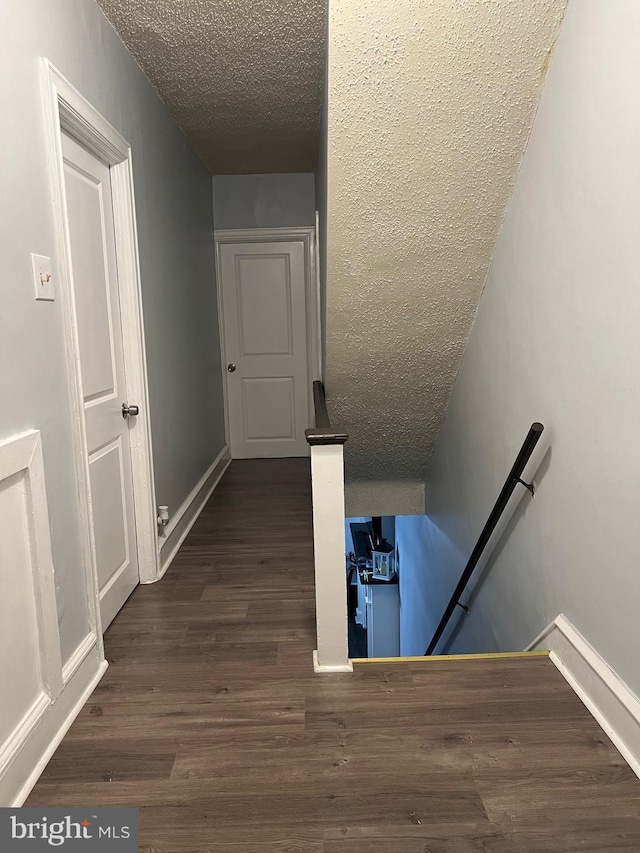 453 Bert Ave, Trenton, NJ 08629 - staircase with a textured ceiling, wood finished floors, and baseboards