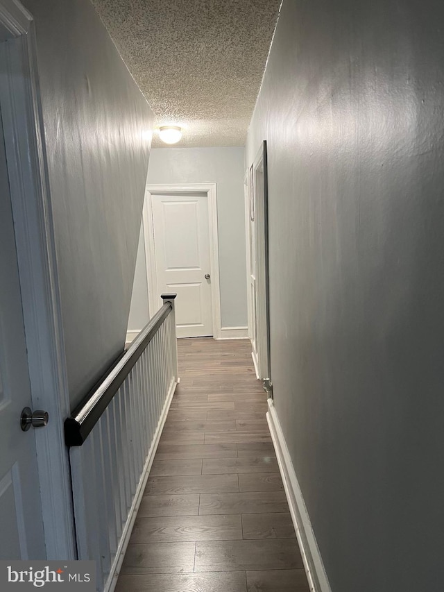 453 Bert Ave, Trenton, NJ 08629 - corridor with an upstairs landing, dark wood-style floors, a textured ceiling, and baseboards