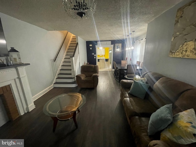 453 Bert Ave, Trenton, NJ 08629 - living room featuring a textured ceiling, stairway, wood finished floors, baseboards, and a chandelier