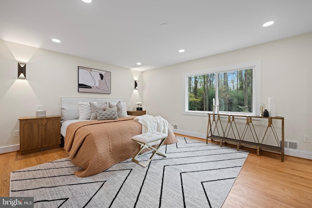 bedroom featuring recessed lighting, baseboards, and light wood-type flooring