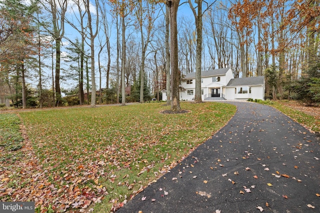 view of front of house with a front yard and asphalt driveway