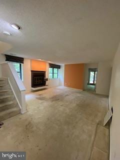 586 Wild Flower Glade, Annapolis, MD 21409 - unfurnished living room with stairway, carpet, and a fireplace