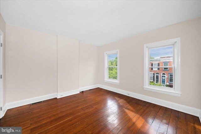 1718 N Scott St, Wilmington, DE 19806 - spare room with baseboards and hardwood / wood-style flooring