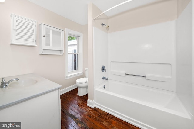 1718 N Scott St, Wilmington, DE 19806 - full bath featuring wood-type flooring, toilet, baseboards, washtub / shower combination, and vanity