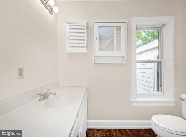 1718 N Scott St, Wilmington, DE 19806 - bathroom with baseboards, wood finished floors, toilet, and vanity