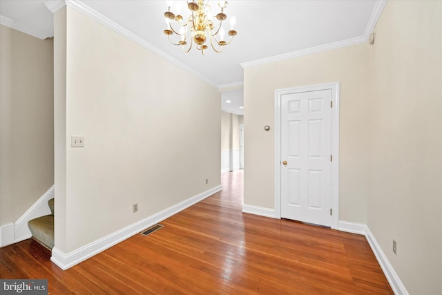 1718 N Scott St, Wilmington, DE 19806 - unfurnished room with wood-type flooring, a chandelier, crown molding, baseboards, and stairway