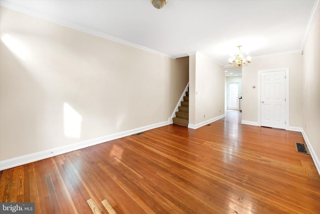 1718 N Scott St, Wilmington, DE 19806 - unfurnished living room featuring a chandelier, stairway, crown molding, baseboards, and wood finished floors
