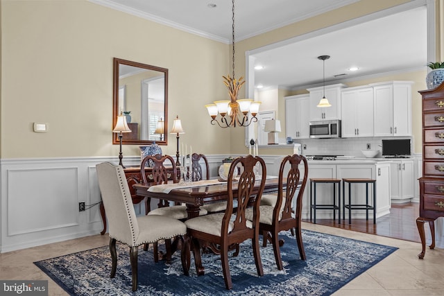 dining room with ornamental molding, a chandelier, light tile patterned floors, wainscoting, and recessed lighting